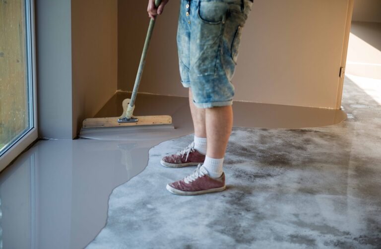 a man applying self leveling in interior floor