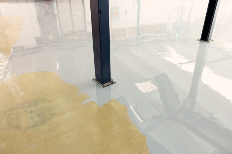 Worker applying epoxy resin in an industrial facility