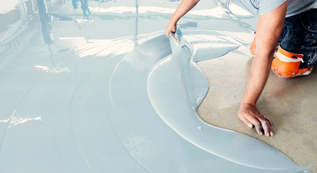 construction-worker-spreading-self-leveling-concrete-on-the-floor