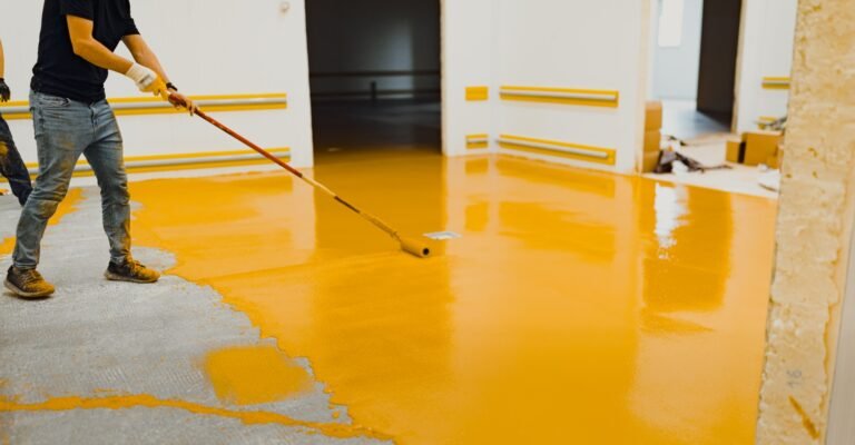 epoxy flooring applicator performs painting works with polyurethane epoxy mortar