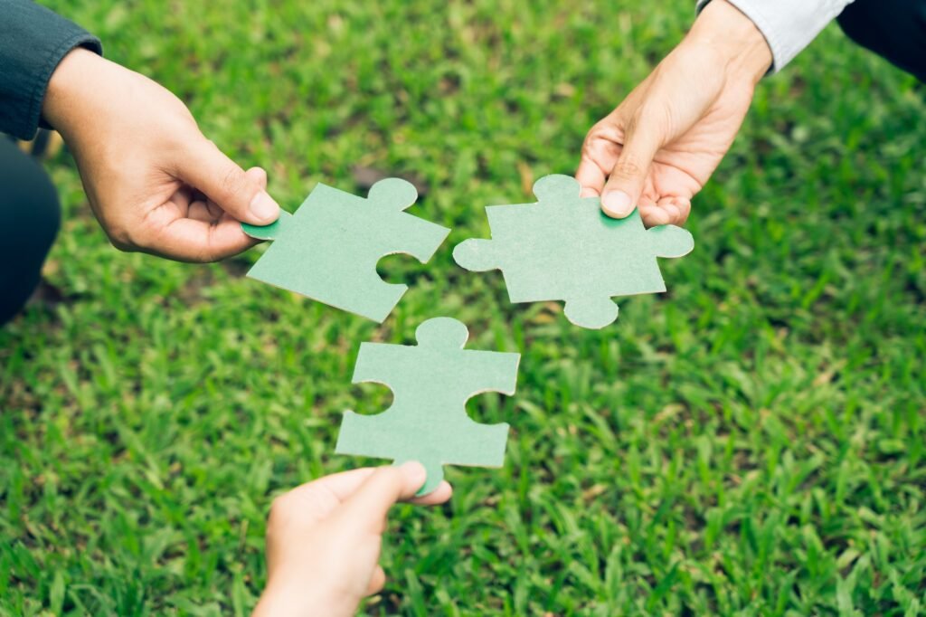 group of business people assembling jigsaw puzzle. The concept of cooperation
