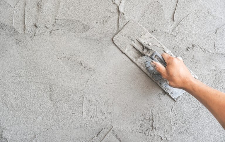 hand-worker-applying-lime-finish-plaster