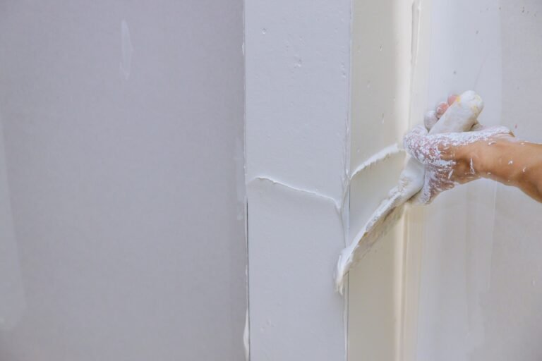 Renovation the wall with putty spreading plaster on wall.