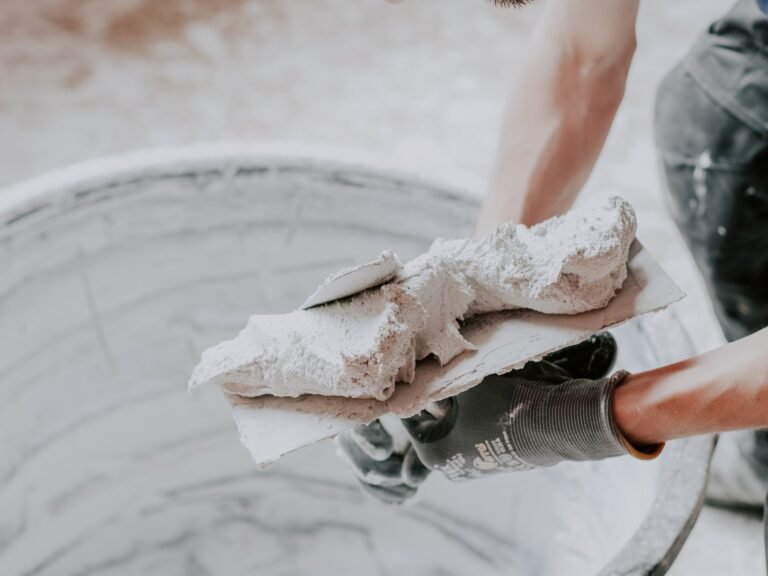 a man applying fresh putty with one spatula to another
