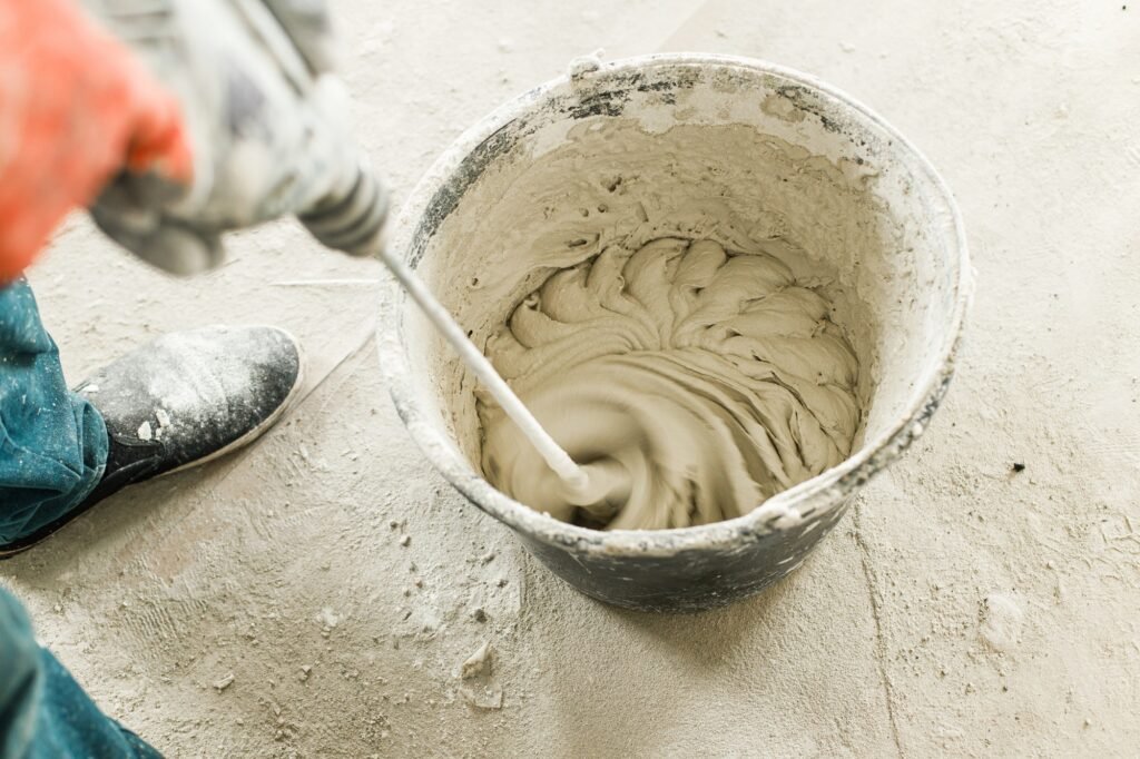 worker-mixing-gypsum-plaster-with-water-for-plastering-walls