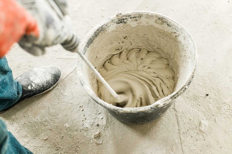 worker-mixing-gypsum-plaster-with-water-for-plastering-walls